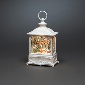 Vannfyllt lykt by og flygende nisseslede